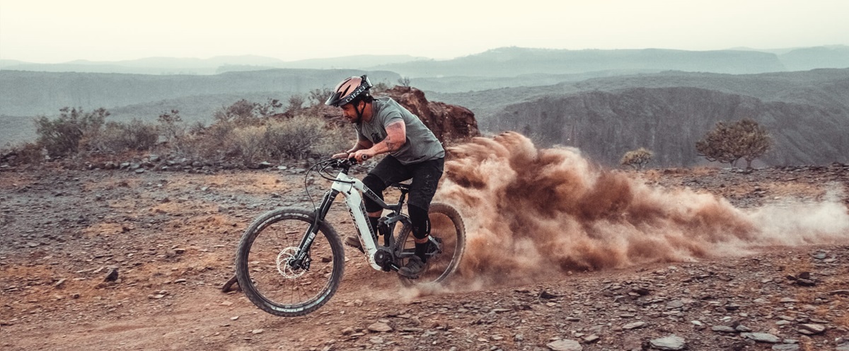 The Haibike Hero Yannick Granieri riding his MTB and kicking up dust with his rear wheel