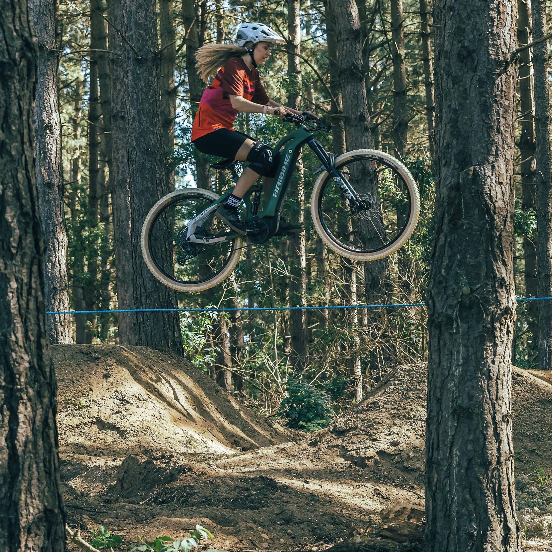 Haibike Hero Kara Beal jumping on a forest MTB track with her AllMtn 6