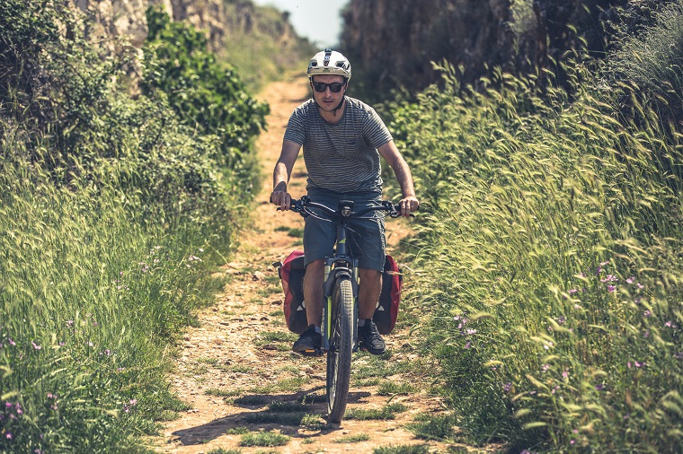 Haibike Hero Maximilian Semsch riding through a field in Croatia on his trekking eBike 