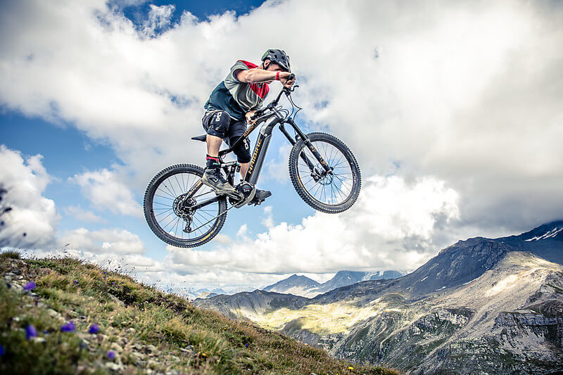Haibike Hero Sam Pilgrim jumps through the air on his mountain bike