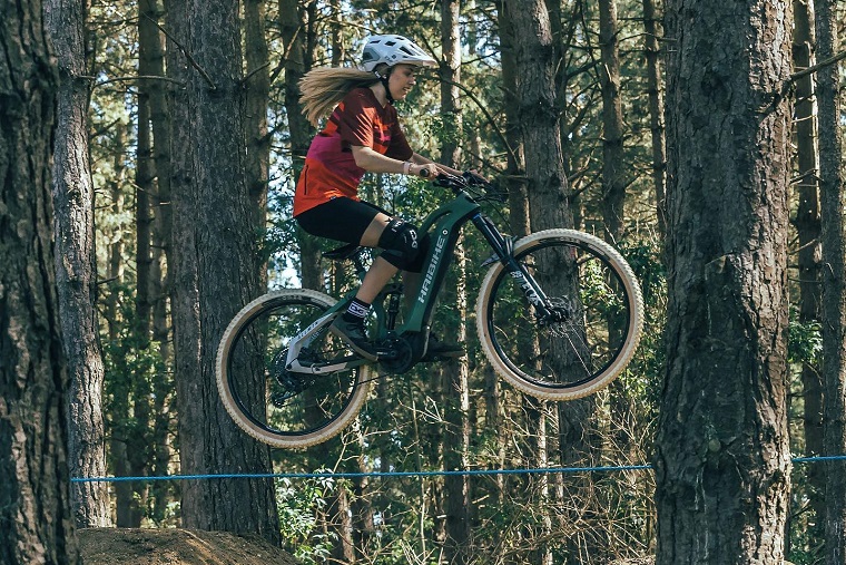 Haibike Hero Kara Beal jumping on a forest MTB track with her AllMtn 6